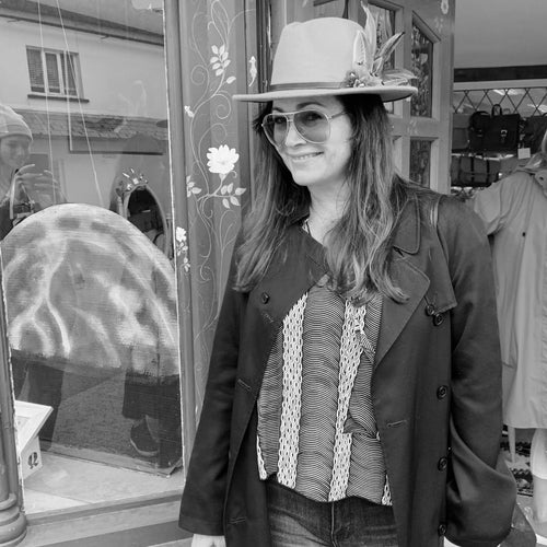black and white image of woman in glasses and casual clothing