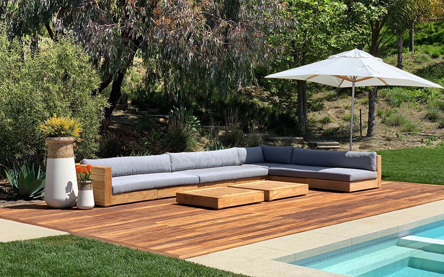 outdoor poolside area with seating and umbrella