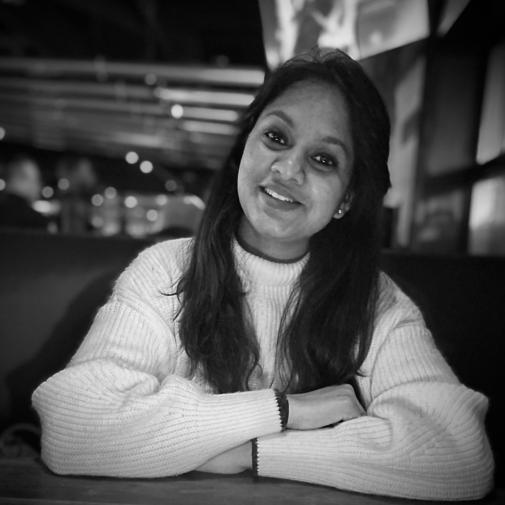 black and white image of woman in white sweater