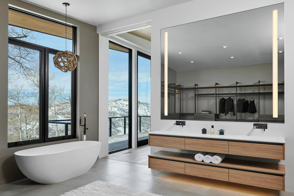 bathroom with large mirror and standalone tub