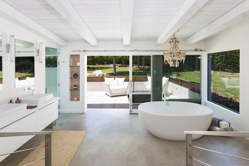 bathroom with standalone tub and chandelier