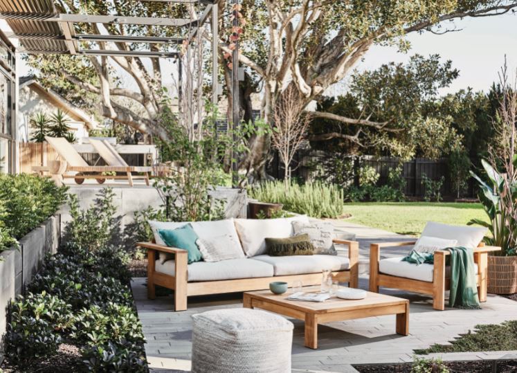 outdoor patio with greenery and gray seating