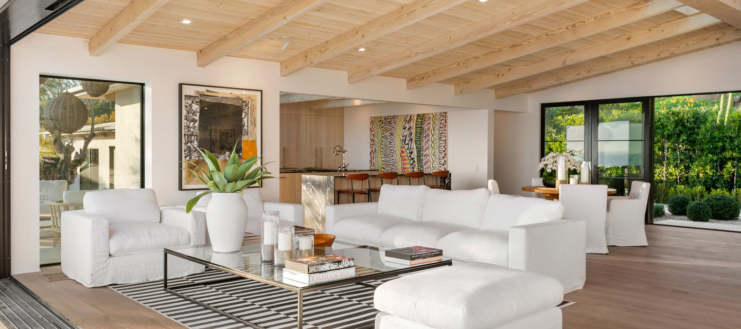 living room with white couches and glass coffee table